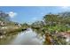 Waterfront view of surrounding houses, with docks and lush greenery at 3930 Elysian Woods Ln, Sarasota, FL 34231