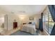 Cozy bedroom with tile flooring, large window, ceiling fan, and closet at 4249 Oakhurst E Cir # 3034, Sarasota, FL 34233