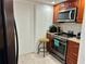 Kitchen with laundry closet and wood cabinets at 4445 46Th W Ave, Bradenton, FL 34210