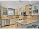 Modern kitchen featuring updated cabinetry and granite countertops at 500 S Washington Dr # 25B, Sarasota, FL 34236