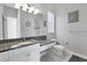 Bathroom with granite countertop, white cabinets, and hexagon tile floor at 504 Mast Dr, Bradenton, FL 34208