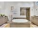 Spa-like bathroom with soaking tub, walk-in shower, and double vanity at 504 Mast Dr, Bradenton, FL 34208
