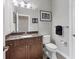 Small bathroom with granite countertop and dark wood cabinets at 504 Mast Dr, Bradenton, FL 34208