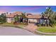 Stunning curb appeal: two-story home with a tile roof and landscaped yard at 504 Mast Dr, Bradenton, FL 34208