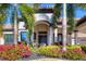 Elegant home entrance with lush landscaping and palm trees at 504 Mast Dr, Bradenton, FL 34208