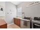 Laundry room with wood cabinets, LG washer and dryer, and built-in shelves at 504 Mast Dr, Bradenton, FL 34208