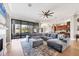 Open-concept living room with hardwood floors, sectional sofa, and access to the kitchen at 504 Mast Dr, Bradenton, FL 34208