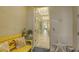 Bright entryway with yellow bench, starfish decor, and view into the home at 505 Tamiami N Trl # 201, Venice, FL 34285