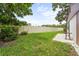 Well-maintained backyard featuring a long, white vinyl fence, mature landscaping, and a small patio area at 5111 26Th St. Ct, W # 53, Bradenton, FL 34207
