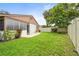 A fully fenced, private backyard with lush green grass and a small brick patio, perfect for relaxing outdoors at 5111 26Th St. Ct, W # 53, Bradenton, FL 34207