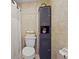 Simple bathroom with toilet, shower and storage cabinet at 5111 26Th St. Ct, W # 53, Bradenton, FL 34207