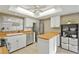 Bright kitchen with white cabinets, wood countertops, and stainless steel appliances at 5111 26Th St. Ct, W # 53, Bradenton, FL 34207