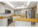 Modern kitchen with white cabinetry, wood countertops, stainless steel appliances, and ample counter space at 5111 26Th St. Ct, W # 53, Bradenton, FL 34207