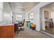 Office featuring a ceiling fan, a desk, and a carpeted floor with a sliding glass door at 5111 26Th St. Ct, W # 53, Bradenton, FL 34207