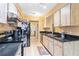 Modern kitchen with black appliances and wood cabinets at 5423 Creeping Hammock Dr, Sarasota, FL 34231