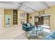 Living room with a fireplace, built-in shelving, and large window looking onto a patio at 5423 Creeping Hammock Dr, Sarasota, FL 34231