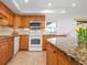 Modern kitchen with wood cabinets and granite countertops at 6143 Wilshire Cir # 19, Sarasota, FL 34238