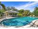 Community pool with a covered cabana and seating area at 6143 Wilshire Cir # 19, Sarasota, FL 34238