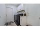 Laundry room with washer, dryer, and white cabinets at 6326 Clark Rd, Sarasota, FL 34241