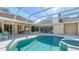 Inviting pool with a screened enclosure and adjacent patio area at 6641 Saint James Xing, University Park, FL 34201