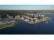 Aerial view of a waterfront community with shops and lush landscaping at 7443 Riviera Cv, Lakewood Ranch, FL 34202