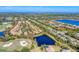 An aerial view showcases the community's layout, including a golf course and lake at 7443 Riviera Cv, Lakewood Ranch, FL 34202