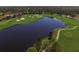 Aerial view of golf course with lake and homes at 7443 Riviera Cv, Lakewood Ranch, FL 34202