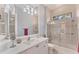 Bathroom with white vanity, bathtub, and shower at 7443 Riviera Cv, Lakewood Ranch, FL 34202