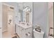 White bathroom vanity with a toilet and view of another room at 7443 Riviera Cv, Lakewood Ranch, FL 34202