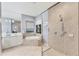 Elegant bathroom with a soaking tub, walk-in shower, and double vanity at 7443 Riviera Cv, Lakewood Ranch, FL 34202