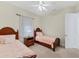Bedroom with two twin beds and ceiling fan at 7443 Riviera Cv, Lakewood Ranch, FL 34202