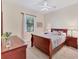 Cozy bedroom with a sleigh bed, nightstands, and a ceiling fan at 7443 Riviera Cv, Lakewood Ranch, FL 34202