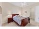 Well-lit bedroom with a wooden sleigh bed and walk-in closet at 7443 Riviera Cv, Lakewood Ranch, FL 34202