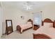Bedroom with two twin beds, a dresser, and mirror at 7443 Riviera Cv, Lakewood Ranch, FL 34202
