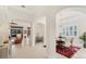 Bright dining room with arches, hardwood floors, and a view to the living room at 7443 Riviera Cv, Lakewood Ranch, FL 34202