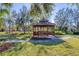 A picturesque gazebo surrounded by trees and a stone pathway at 7443 Riviera Cv, Lakewood Ranch, FL 34202