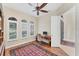 Bright home office features built-in shelving, hardwood floors, and plantation shutters at 7443 Riviera Cv, Lakewood Ranch, FL 34202