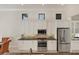 Modern kitchen with white cabinets, stainless steel appliances, and granite countertops at 7443 Riviera Cv, Lakewood Ranch, FL 34202