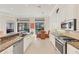 Bright kitchen features granite counters, stainless steel appliances, and breakfast nook at 7443 Riviera Cv, Lakewood Ranch, FL 34202