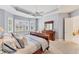Main bedroom with a king-size sleigh bed and plenty of natural light from large windows at 7443 Riviera Cv, Lakewood Ranch, FL 34202