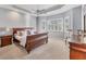 Spacious main bedroom with a sleigh bed, ample natural light, and carpeted floors at 7443 Riviera Cv, Lakewood Ranch, FL 34202