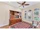 Home office with built-in wooden shelving and large windows at 7443 Riviera Cv, Lakewood Ranch, FL 34202