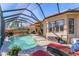 Lovely pool with screened enclosure, patio furniture, and water feature at 7443 Riviera Cv, Lakewood Ranch, FL 34202