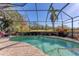 Enjoy the screened-in pool area with a view of nature at 7443 Riviera Cv, Lakewood Ranch, FL 34202