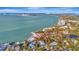 Aerial view of waterfront home with beach access and stunning water views at 77 Sandy Hook N Rd, Sarasota, FL 34242