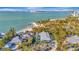 Breathtaking aerial view of coastal home with private beach access and stunning ocean views at 77 Sandy Hook N Rd, Sarasota, FL 34242