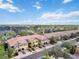 An aerial view of a residential community with townhomes, lush landscaping, and ample parking at 7786 Moonstone Dr # 7-204, Sarasota, FL 34233