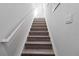 Staircase with wooden steps and white railing at 7786 Moonstone Dr # 7-204, Sarasota, FL 34233