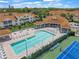 Aerial view of community pool, tennis courts, and clubhouse at 8369 Wingate Dr # 2114, Sarasota, FL 34238