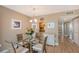 Charming dining area with glass table and wicker chairs, adjacent to kitchen at 8625 Midnight Pass Rd # 505B, Sarasota, FL 34242